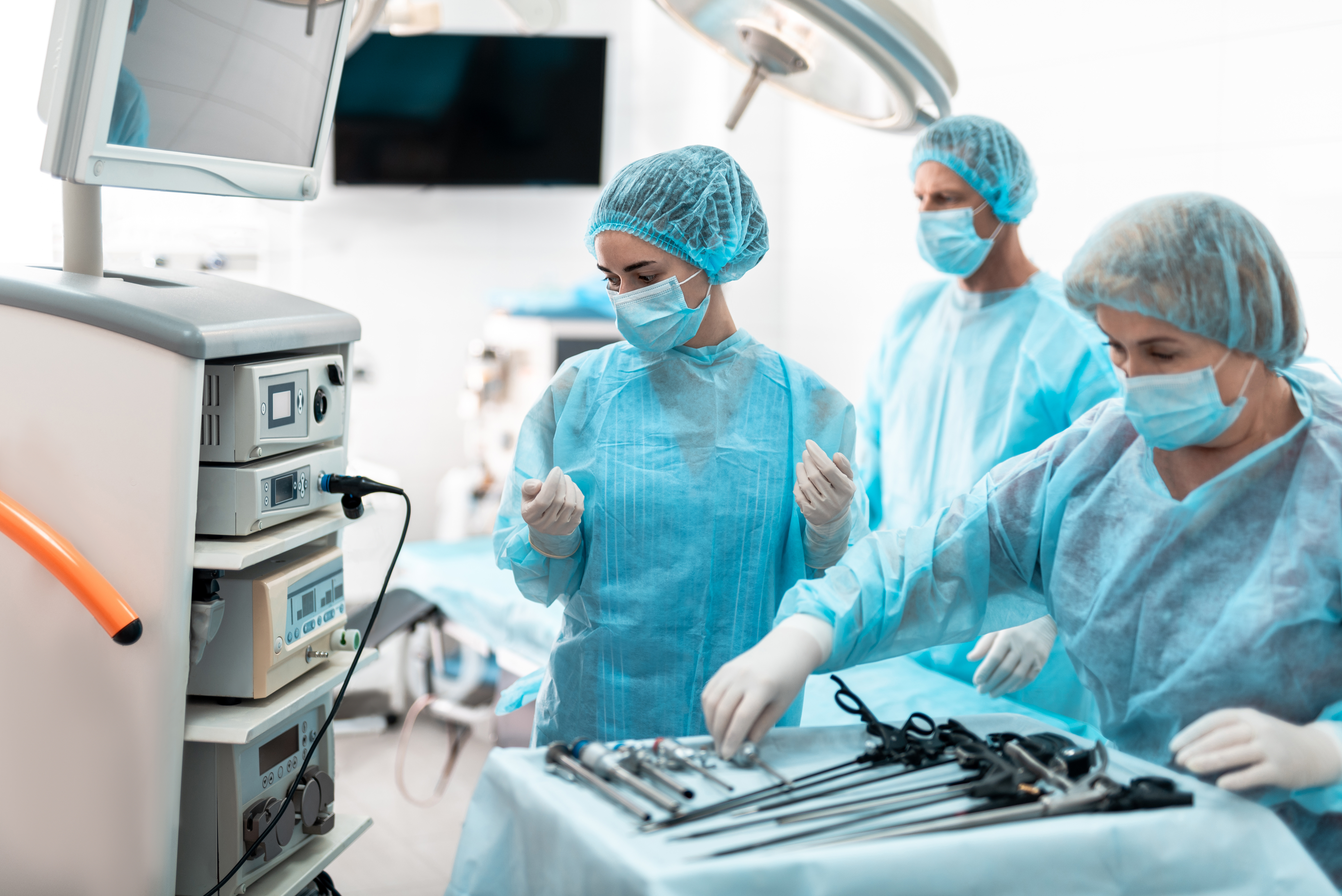 a women wearing scrubs working on a medical equipment.